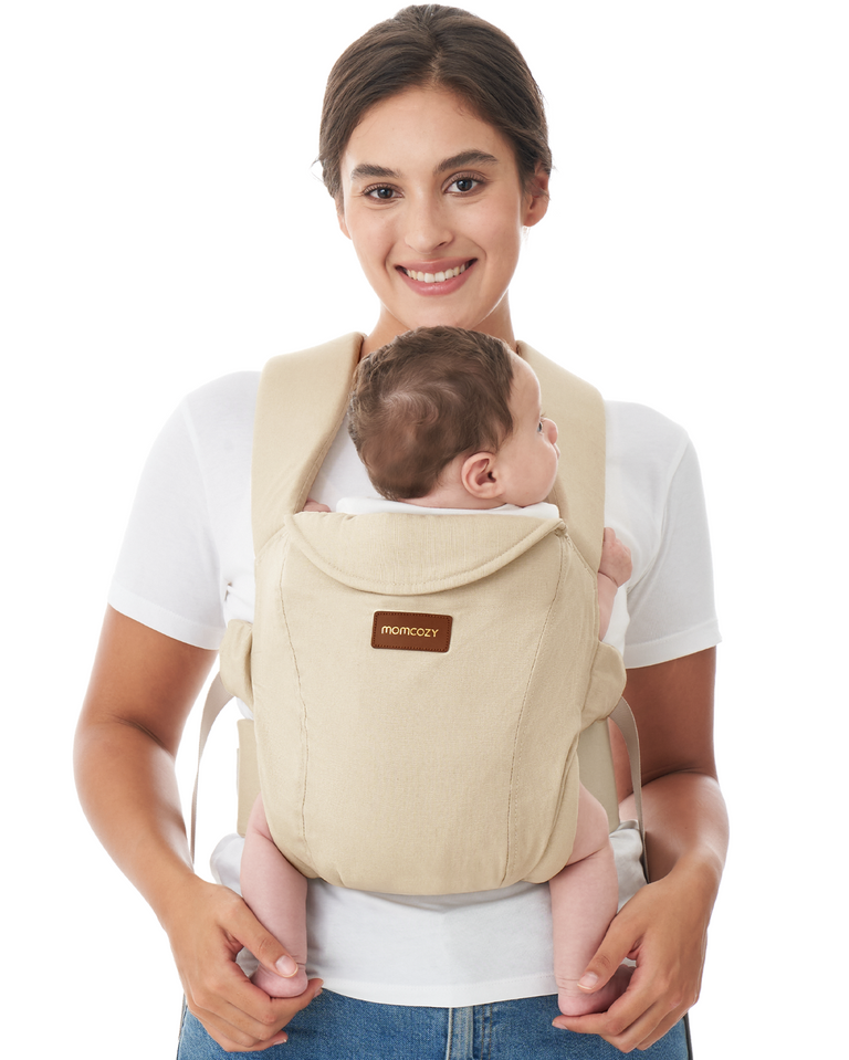 Translation missing: en.Momcozy WeeSnug beige newborn carrier, baby held by smiling mother. Ergonomic design, comfortable baby carrier for newborns